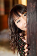girl playing hide and seek in temple