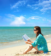 Girl reading a book on the beach Girl reading a book on the beach