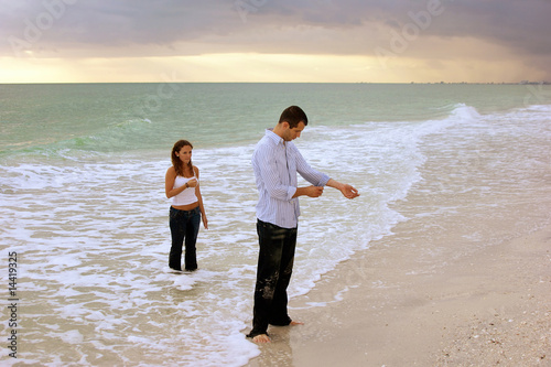 Photo: fully clothed couple standing in ocean at sunset fully clothed couple standing in ocean at sunset
