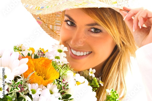 Photo: young blond girl with flowers young blond girl with flowers