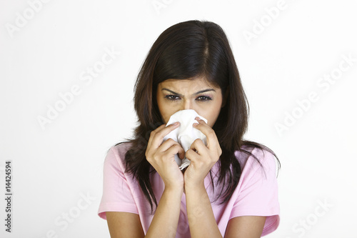 Photo: Teenage girl with tissue suffering with cold Teenage girl with tissue suffering with cold