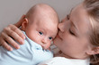 Beautiful baby of three months old in his mothers hands.