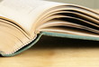 Open vintage book closeup on wooden table