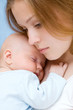 Beautiful baby of three months old in his mothers hands.