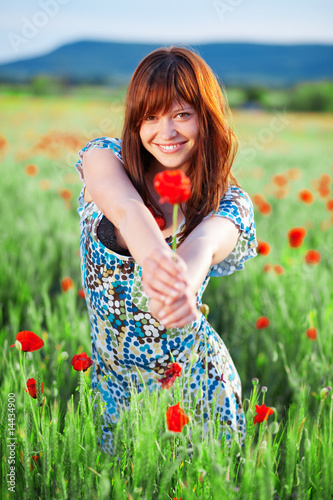 Photo: Smiling girl giving flower Smiling girl giving flower