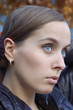 Portrait of a young woman making a pony-tail Portrait of a young woman making a pony-tail