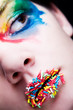 Colorful make-up with candy on her lips Colorful make-up with candy on her lips