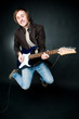 Jumping man with electro guitar