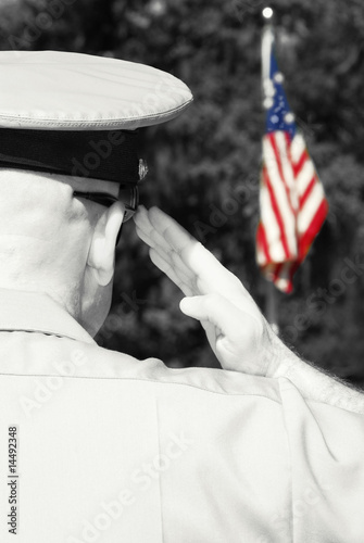Photo: Military officer saluting flag Military officer saluting flag