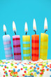Five birthday candles on blue background
