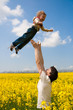 father with daughter on the rape field