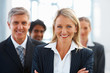 Cute business woman with group of colleagues at the back