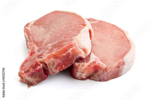 Photo: raw pork chops on white background raw pork chops on white background