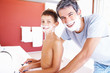Portrait of a little boy with shaving cream on the face along wi