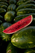 Photo: Watermelon Slice on Bed of Whole Watermelons Watermelon Slice on Bed of Whole Watermelons