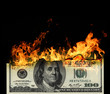 Burning dollars close up over black background
