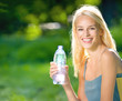 Young woman with bottle of water outdoors Young woman with bottle of water outdoors
