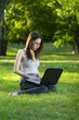 student with laptop outdoors