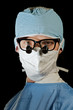 serious surgeon in scrubs and magnifying microsurgery glasses serious surgeon in scrubs and magnifying microsurgery glasses