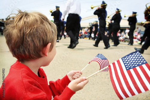 Photo: Young boy watching the memorial day parade Young boy watching the memorial day parade