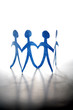 Four paper dolls on plain background