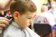 Boy cut in hairdresser's machine
