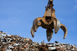 a crane grabber up on the metal  heap