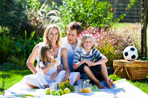 Photo: Happy family having a picnic Happy family having a picnic