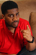 Male on couch - pointing finger