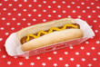 Photo: Hotdog with mustard in patriotic tablecloth Hotdog with mustard in patriotic tablecloth
