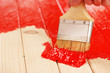 Covering wooden surface with red paint