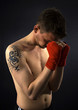 portrait of young karatist with tattoo and bandage. Low key imag