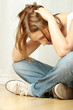Young female sitting on the flor - depression