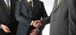 Three businessmen cooperation and handshake