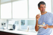 Mature holding his breakfast plate, thoughtful