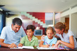Children with their parents assisting them in the homework