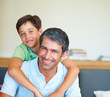 Young boy with his arms around his father