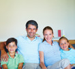 Modern happy family sitting in the living room