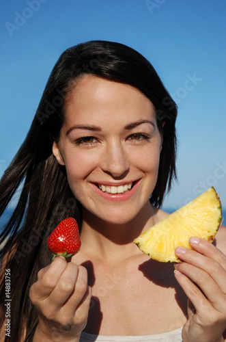 Photo: Happy woman enjoying a healthy snack Happy woman enjoying a healthy snack