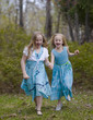 Sisters Running in Spring Dresses