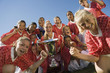 Girls' soccer team 13-17 holding trophy