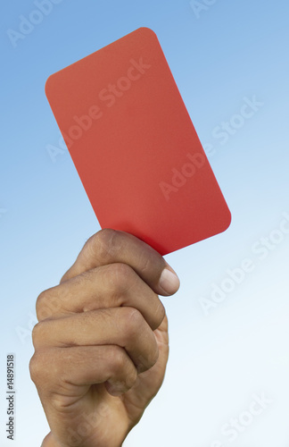 Photo: Soccer referee holding up red card, close-up on hand Soccer referee holding up red card, close-up on hand