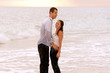 Photo: wet couple at beach laughing wet couple at beach laughing