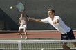 Doubles Player stretching, Hitting tennis ball with forehand near net