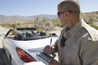 Police officer writing a ticket for a convertible driver