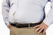 Overweight Man standing with unbuttoned shirt, hands on hip, mid section