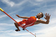 High Jumper in mid air over bar, low angle view