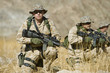 Soldiers with rifles in field