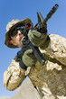 Soldier aiming rifle, outdoors, low angle view