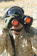 Soldier using binoculars, outdoors, close-up